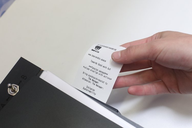 Printed receipt emerging from the station, summarizing the participant’s choices and flagging any value–decision misalignments.